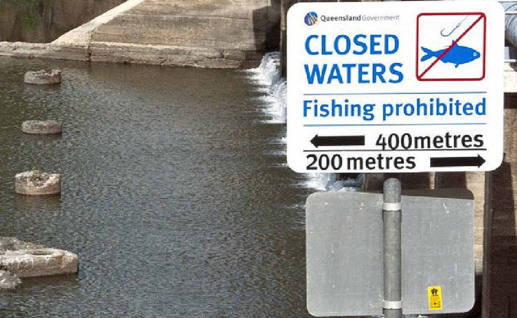 Young people stand on rocks to catch fish at the Mt Crosby weir. Fishing is not allowed from 200m upstream to 400m downstream of the bridge. Young people stand on rocks to catch fish at the Mt Crosby weir. Fishing is not allowed from 200m upstream to 400m downstream of the bridge.